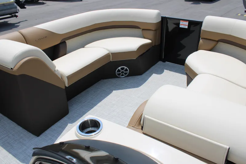 Slide: The Image of 2023 Lowe SS210 Super Sport pontoon boat interior with beige seating and cup holder. - 11