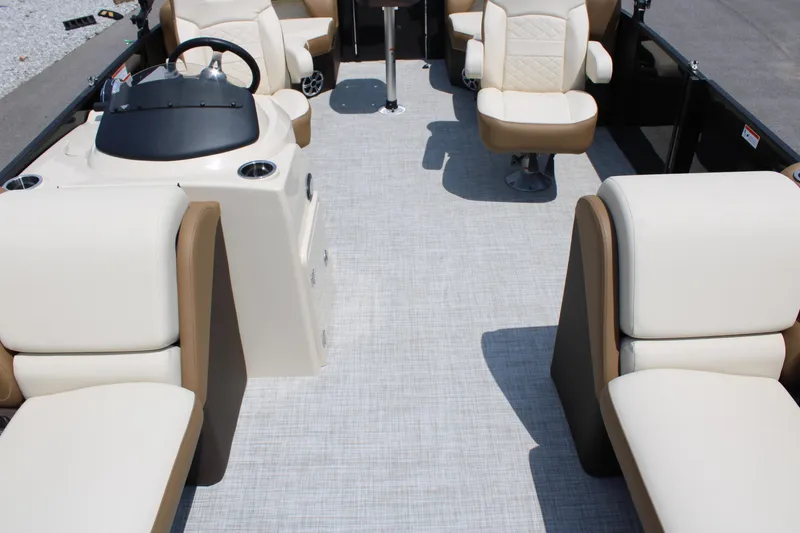 Slide: The Image of 2023 Lowe SS210 Super Sport boat interior with beige seating and steering console. - 3