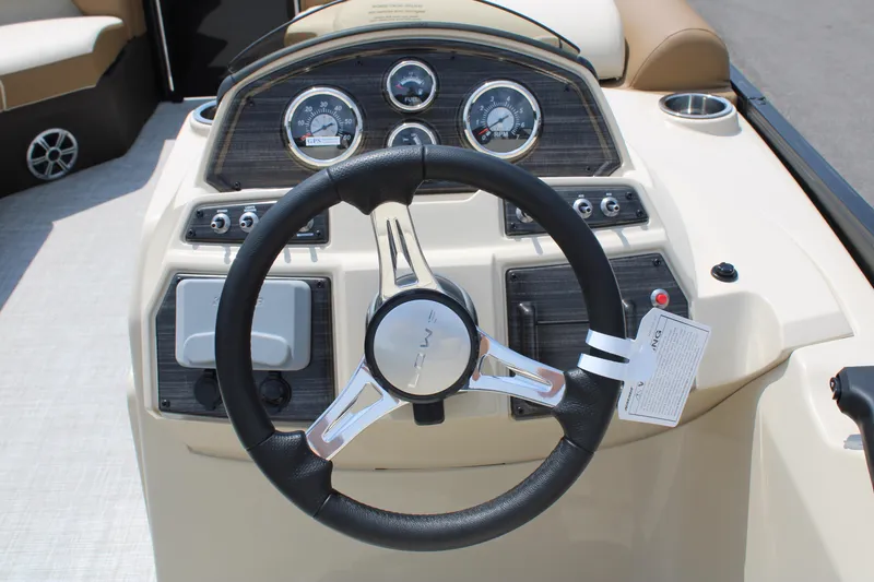 Slide: The Image of 2023 Lowe SS210 Super Sport boat dashboard with steering wheel and gauges. - 9