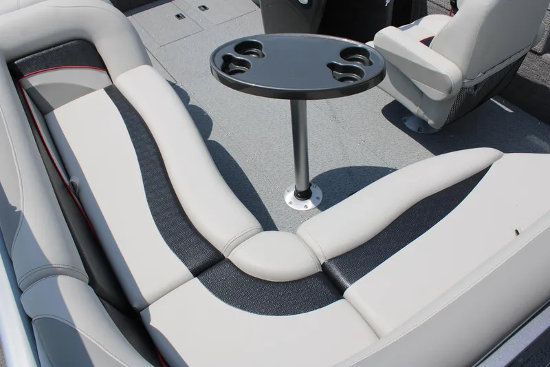 Slide: The Image of 2023 Lowe SD224 Sport Deck interior with seating and cupholder table. - 11
