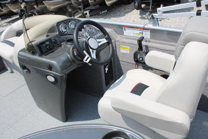 Slide: The Image of 2023 Lowe SD224 Sport Deck boat cockpit with steering wheel and captain's chair. - 13