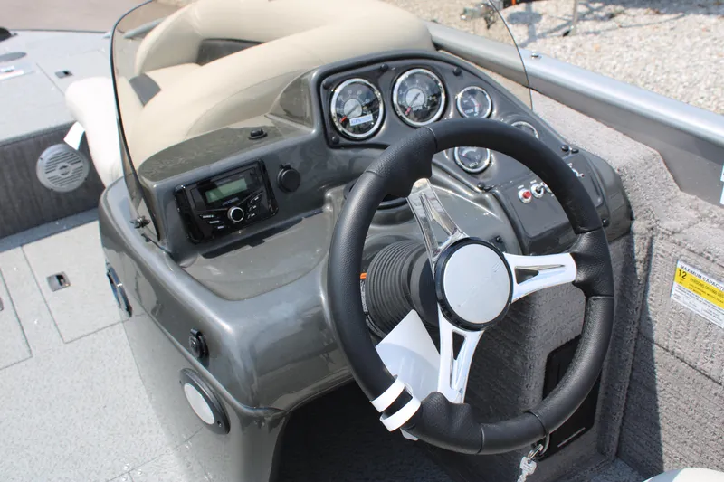 Slide: The Image of 2023 Lowe SD224 Sport Deck boat dashboard with steering wheel and control gauges. - 14