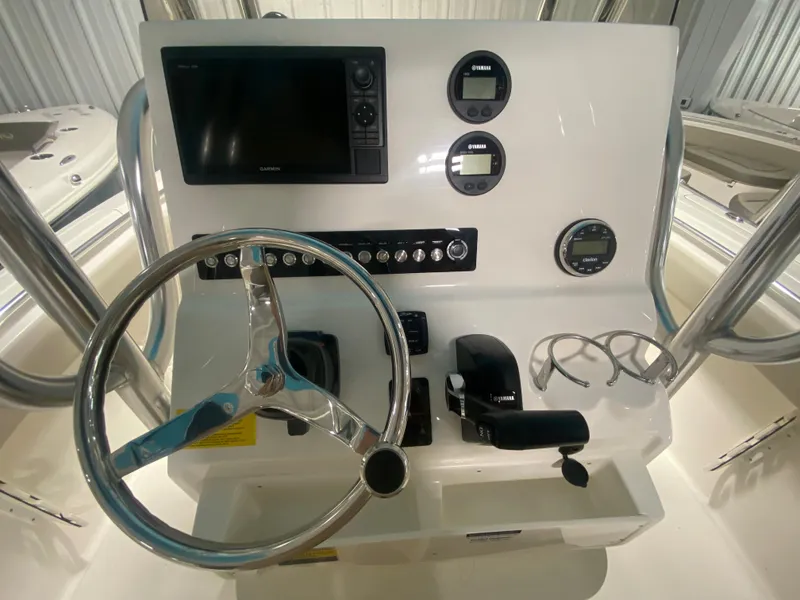 Slide: The Image of 2024 Key West 239 FS boat console with steering wheel, gauges, and navigation system. - 14