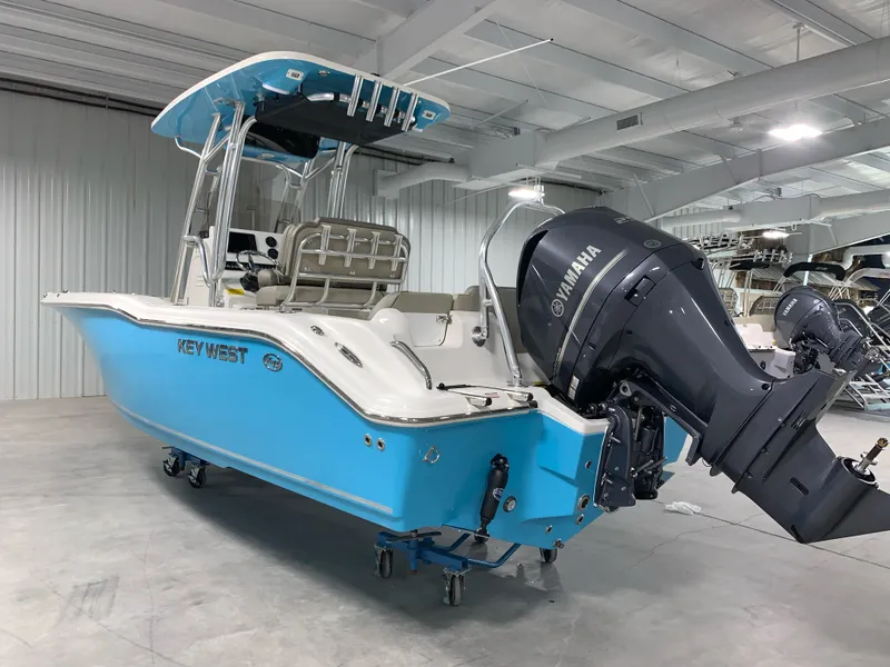 Slide: The Image of 2024 Key West 239 FS boat with Yamaha outboard motor in showroom. - 2