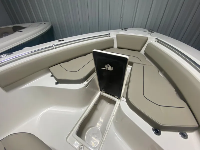 Slide: The Image of 2024 Key West 239 FS boat interior with cushioned seating and storage compartment. - 20