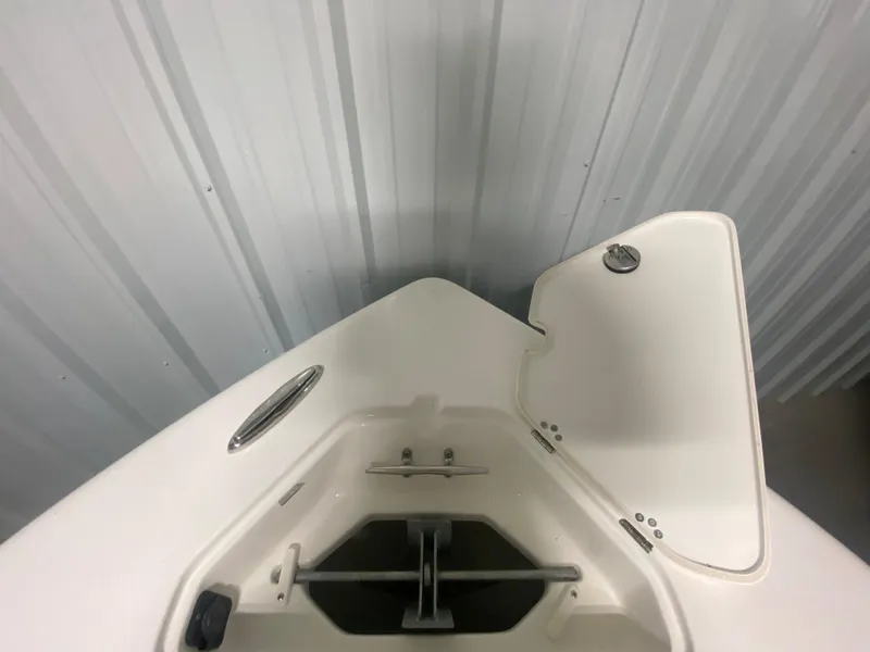 Slide: The Image of 2024 Key West 239 FS boat anchor storage compartment with open hatch. - 24