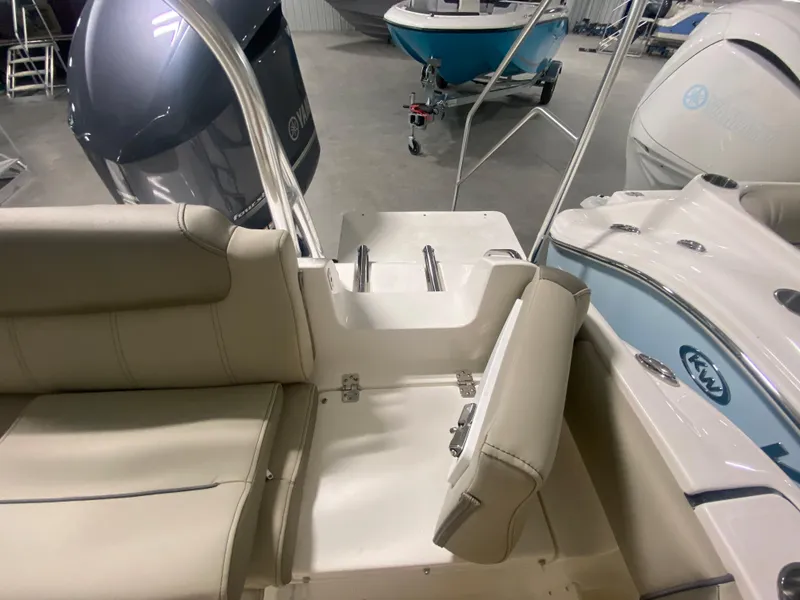 Slide: The Image of 2024 Key West 239 FS boat interior with seating and engine view. - 7