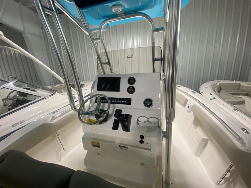 Slide: The Image of 2024 Key West 239 FS boat console with steering wheel and controls. - 9