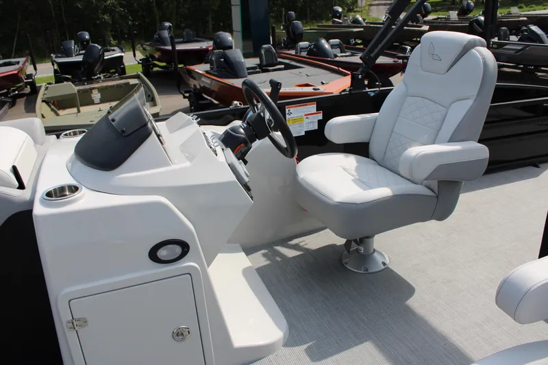 Slide: The Image of 2023 Lowe SS210 Super Sport boat helm with captain's chair and steering console. - 11