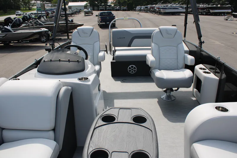 Slide: The Image of 2023 Lowe SS210 Super Sport pontoon boat interior with white seating and helm. - 5