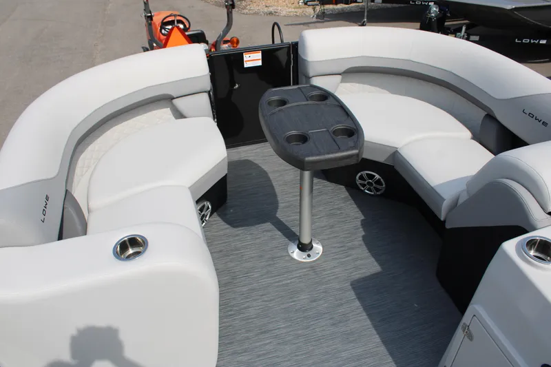 Slide: The Image of 2023 Lowe SS210 Super Sport pontoon boat with spacious seating and a central table. - 6
