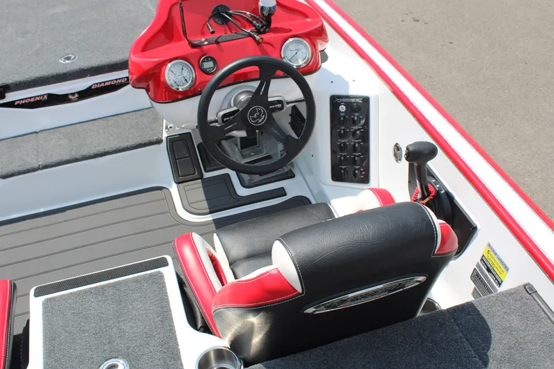 Slide: The Image of 2024 Phoenix 21 PHX boat cockpit with steering wheel and control panel. - 13