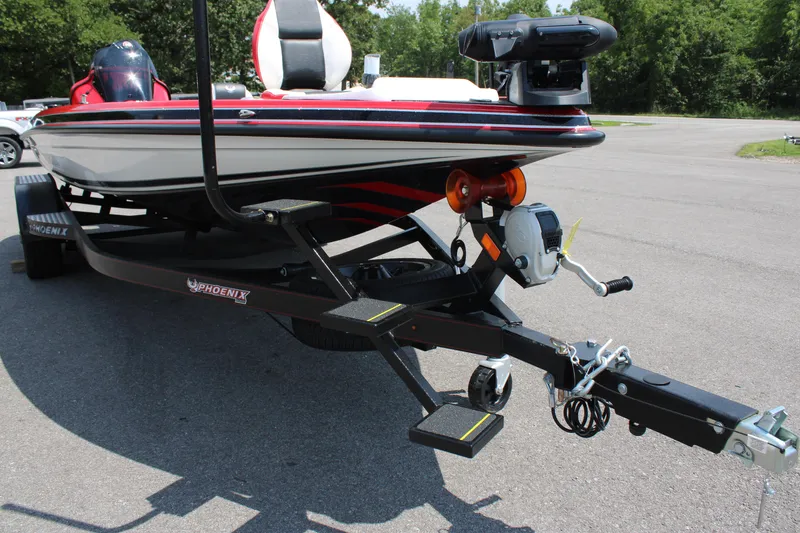 Slide: The Image of 2024 Phoenix 21 PHX boat on a trailer in a parking lot. - 18
