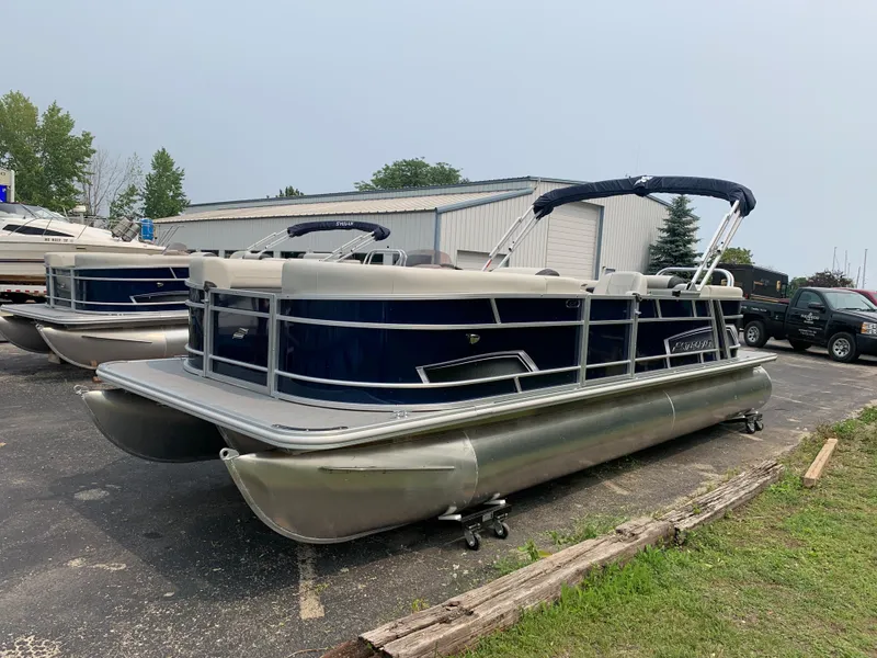 The Image of 2023 Starcraft EX 24 R pontoon boat in a parking lot. - 0