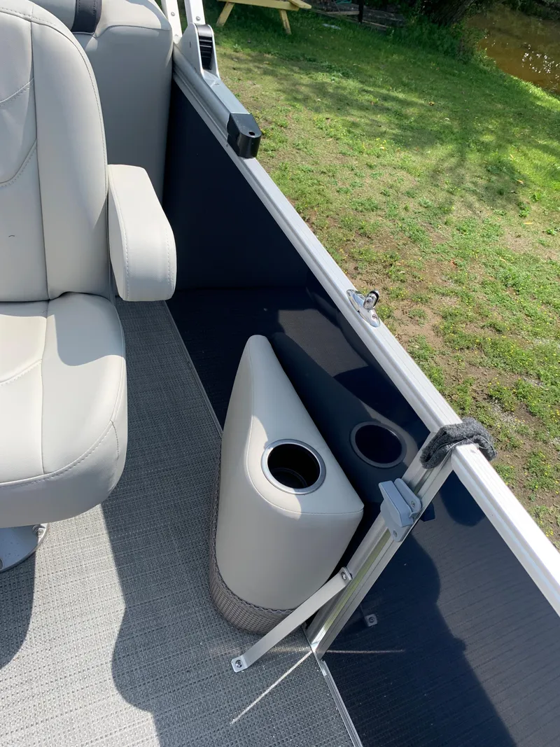 Slide: The Image of 2023 Starcraft EX 24 R boat interior with cup holders and seating. - 11