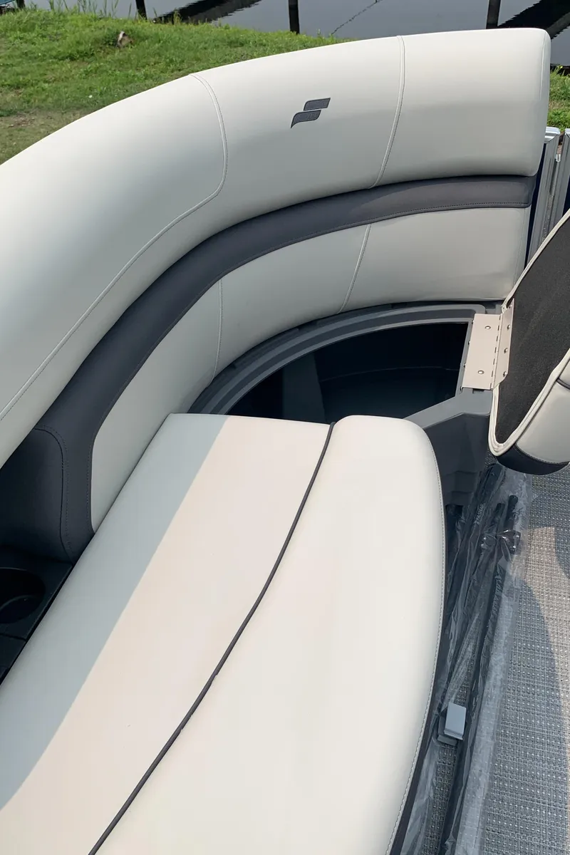 Slide: The Image of 2023 Starcraft EX 24 R boat interior with white and gray seating. - 13