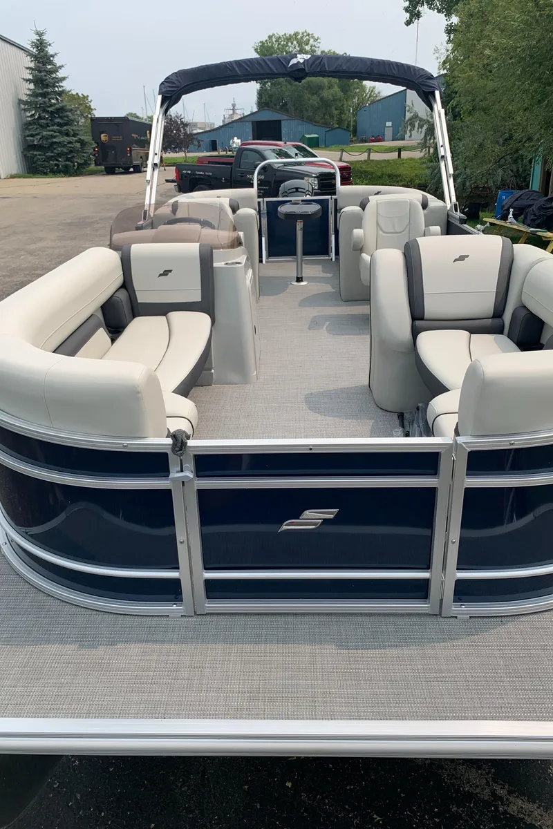 Slide: The Image of 2023 Starcraft EX 24 R pontoon boat with spacious seating and modern design. - 16