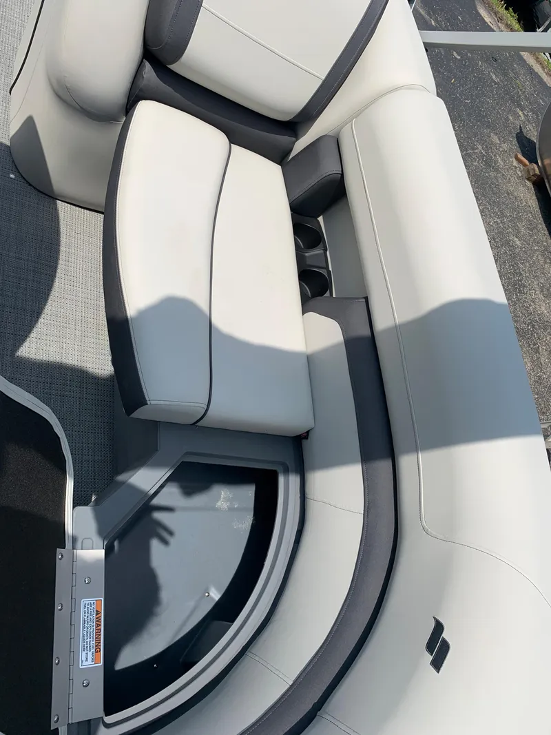 Slide: The Image of 2023 Starcraft EX 24 R boat interior seating with gray and white upholstery. - 17