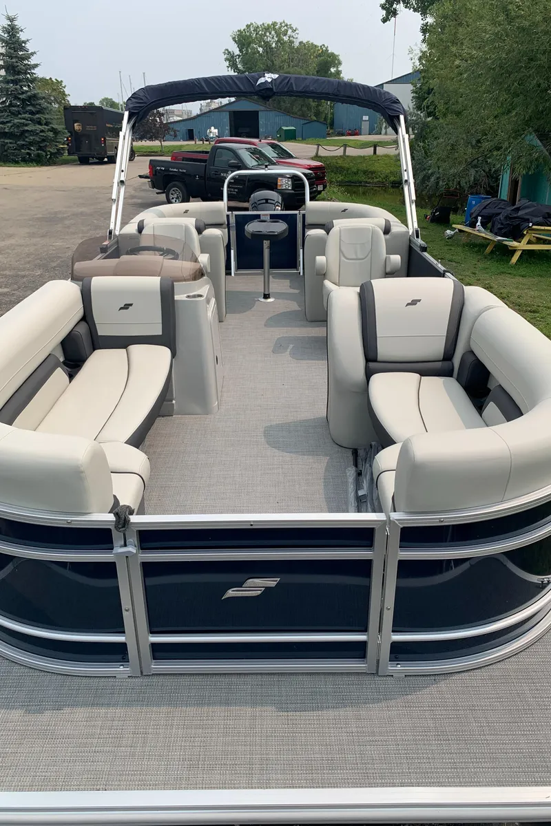 Slide: The Image of 2023 Starcraft EX 24 R pontoon boat with spacious seating and modern design. - 18
