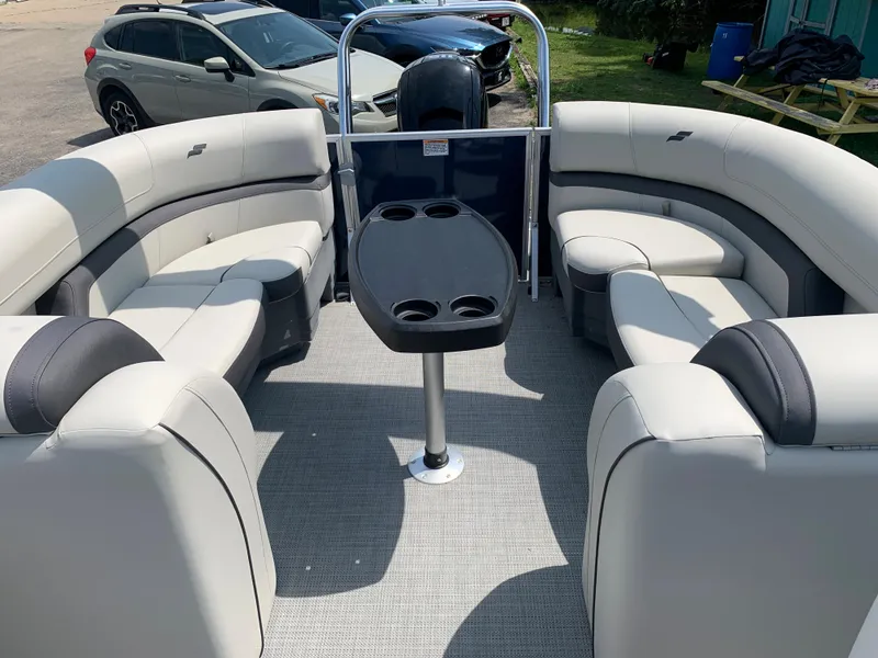 Slide: The Image of 2023 Starcraft EX 24 R pontoon boat interior with spacious seating and table. - 4