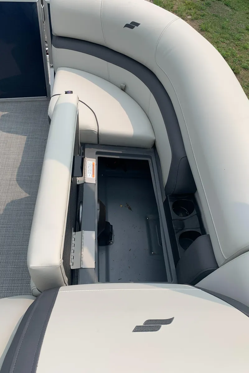 Slide: The Image of 2023 Starcraft EX 24 R pontoon boat with open storage compartment. - 7