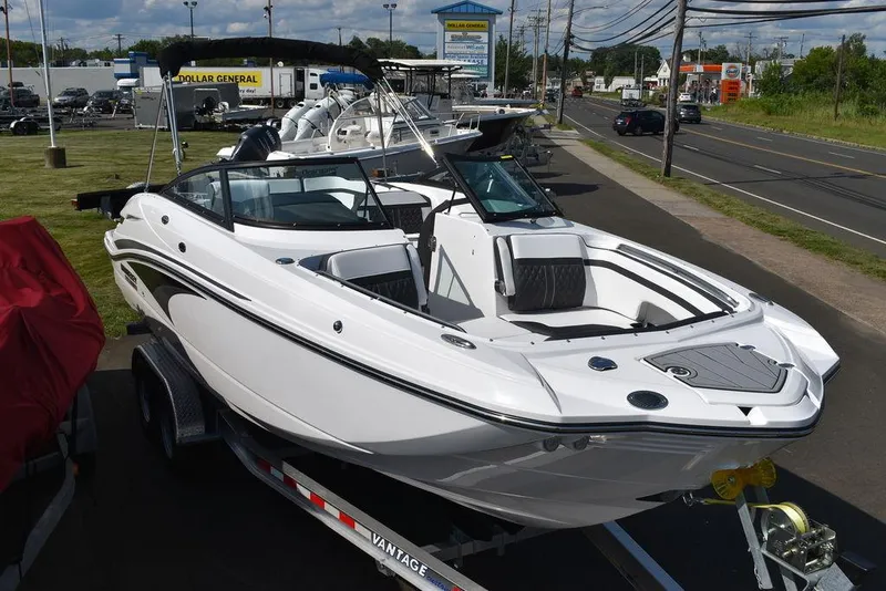 Slide: The Image of 2024 Monterey M6 boat on a trailer, displayed at a dealership. - 10