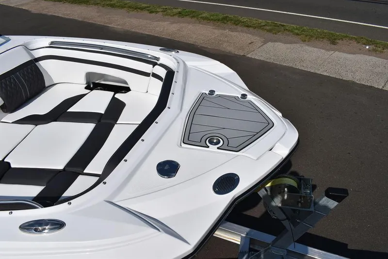 Slide: The Image of 2024 Monterey M6 boat interior, white and black seating, docked on trailer. - 11