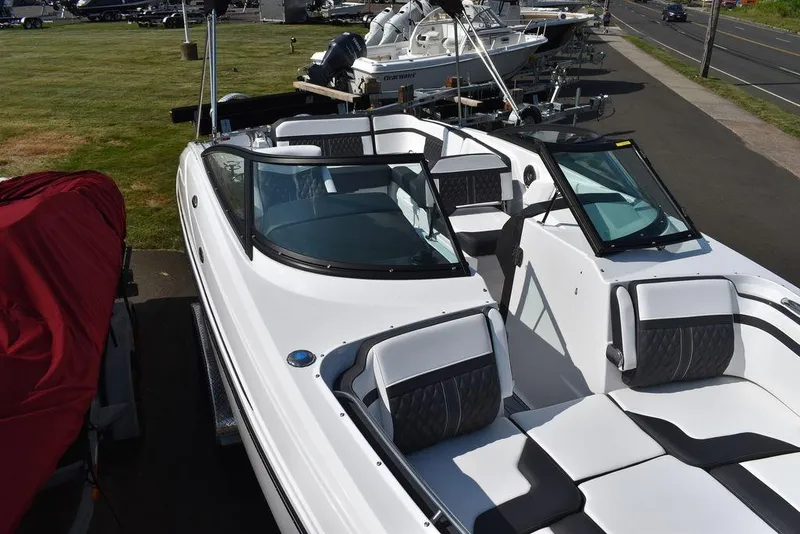 Slide: The Image of 2024 Monterey M6 boat with white and black interior, docked at a marina. - 12