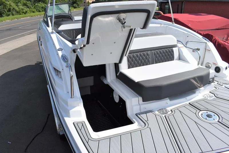 Slide: The Image of 2024 Monterey M6 boat with open storage compartment and cushioned seating. - 17