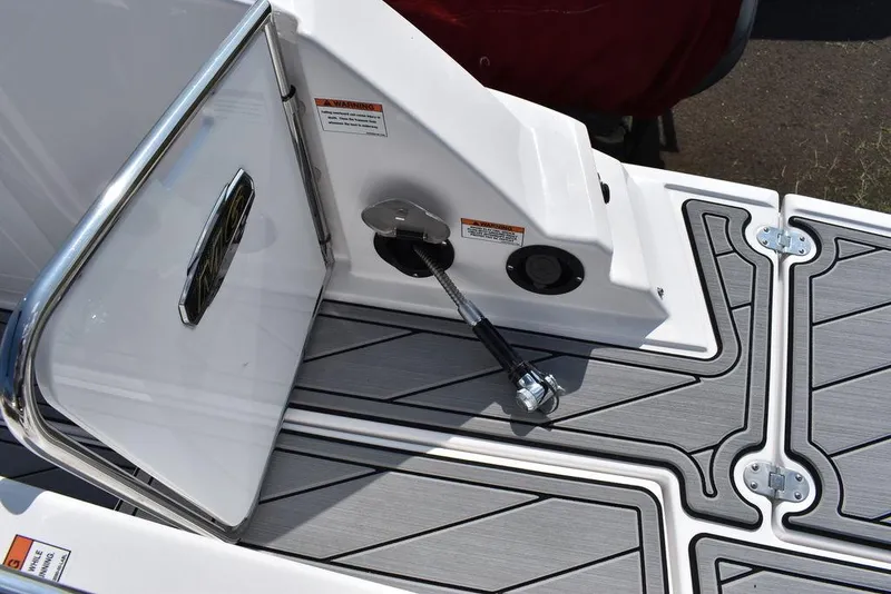 Slide: The Image of 2024 Monterey M6 boat deck with storage compartment and fuel cap. - 20