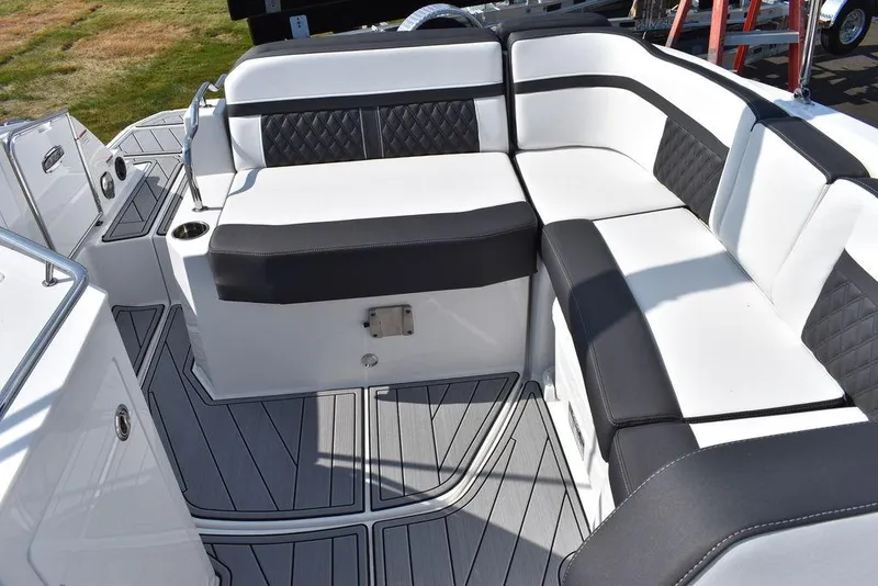Slide: The Image of 2024 Monterey M6 boat interior with black and white cushioned seating. - 25
