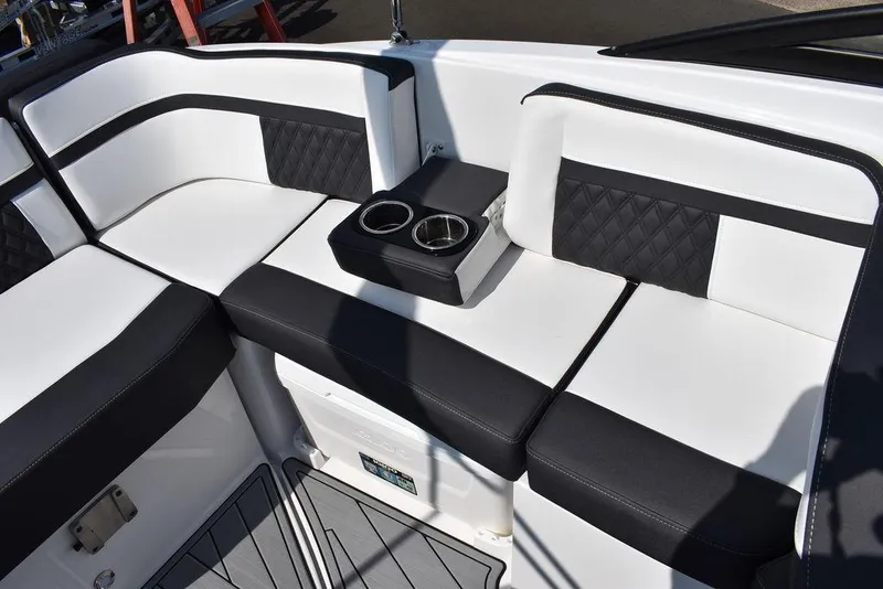 Slide: The Image of 2024 Monterey M6 boat interior with black and white seating and cup holders. - 28