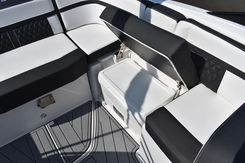 Slide: The Image of 2024 Monterey M6 boat interior with black and white seating and storage compartment. - 29