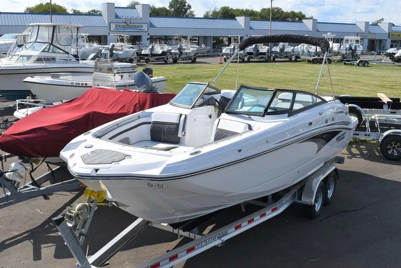 Slide: The Image of 2024 Monterey M6 boat on trailer at dealership, surrounded by other boats. - 3