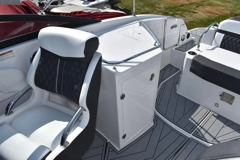 Slide: The Image of 2024 Monterey M6 boat interior with white and black seating and storage compartments. - 35