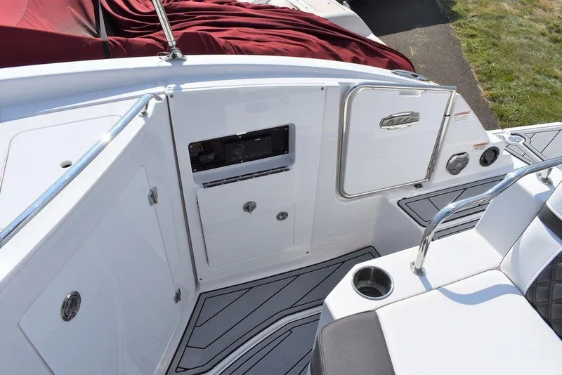 Slide: The Image of 2024 Monterey M6 boat interior with white seating and storage compartments. - 40