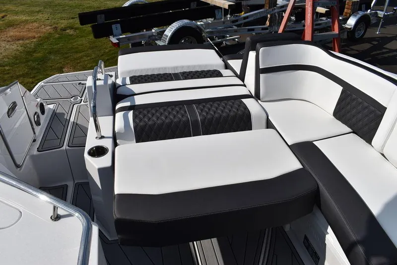 Slide: The Image of 2024 Monterey M6 boat with luxurious black and white seating on deck. - 42