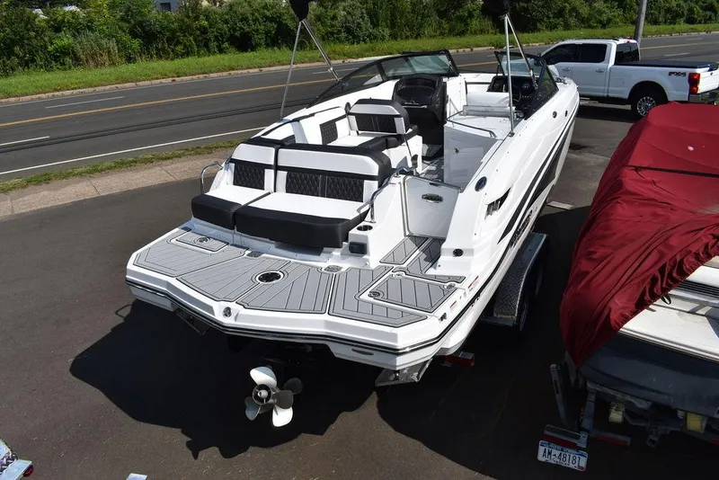 Slide: The Image of 2024 Monterey M6 boat on trailer, rear view, parked near road. - 7