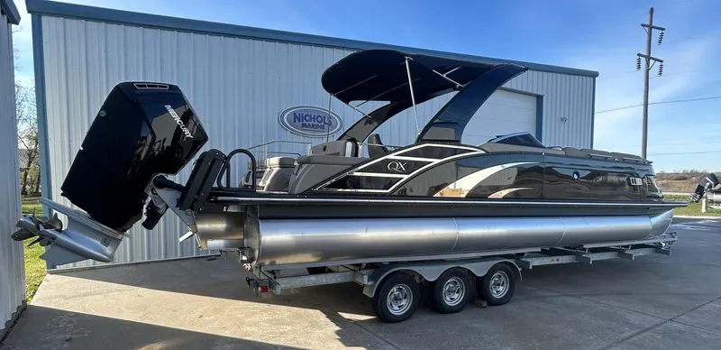 Slide: The Image of 2023 Bennington 28 QXSBW pontoon boat with sleek design and powerful outboard motor. - 2