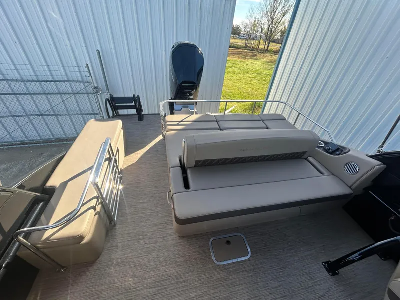 Slide: The Image of 2023 Bennington 28 QXSBW boat interior with beige seating and modern design. - 8