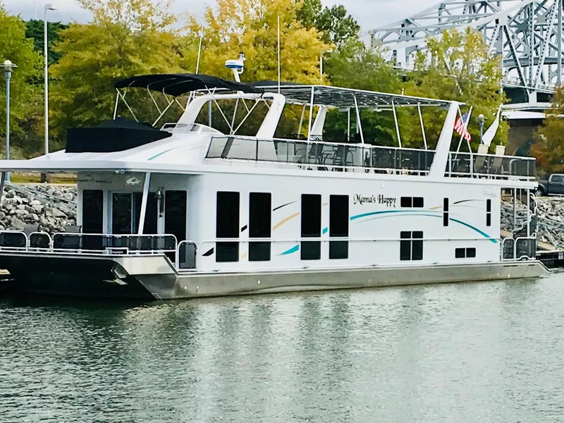 The Image of Thoroughbred 67x17 2016 houseboat docked near trees and bridge. - 0