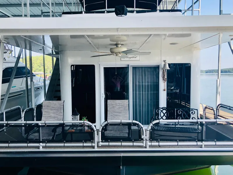 Slide: The Image of Thoroughbred 67x17 2016 houseboat with outdoor seating and lake view. - 10