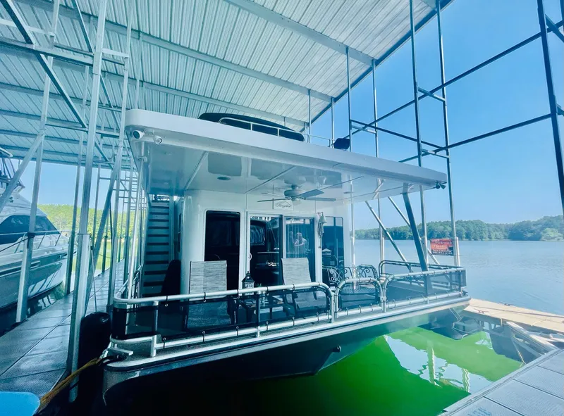 Slide: The Image of 2016 Thoroughbred 67x17 houseboat docked in a marina. - 11