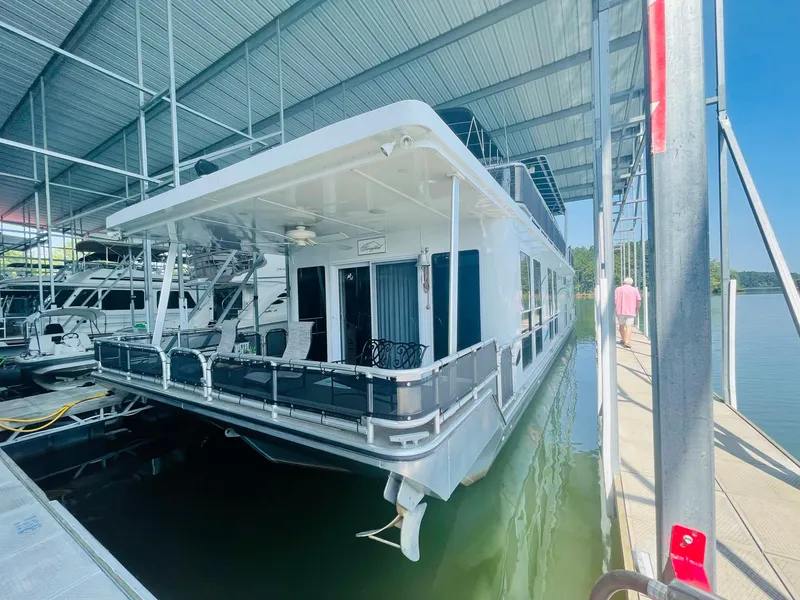 Slide: The Image of 2016 Thoroughbred 67x17 houseboat docked under a covered marina. - 12