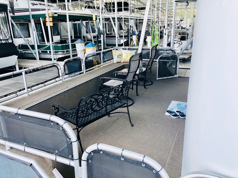 Slide: The Image of Outdoor seating area on a 2016 Thoroughbred 67x17 houseboat docked at a marina. - 13
