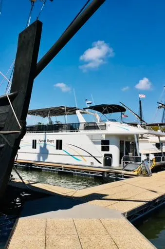 Slide: The Image of 2016 Thoroughbred 67x17 yacht docked at marina on a sunny day. - 2