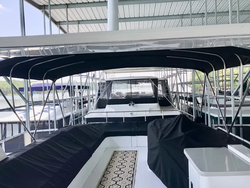 Slide: The Image of 2016 Thoroughbred 67x17 yacht with covered deck and seating area in marina. - 24