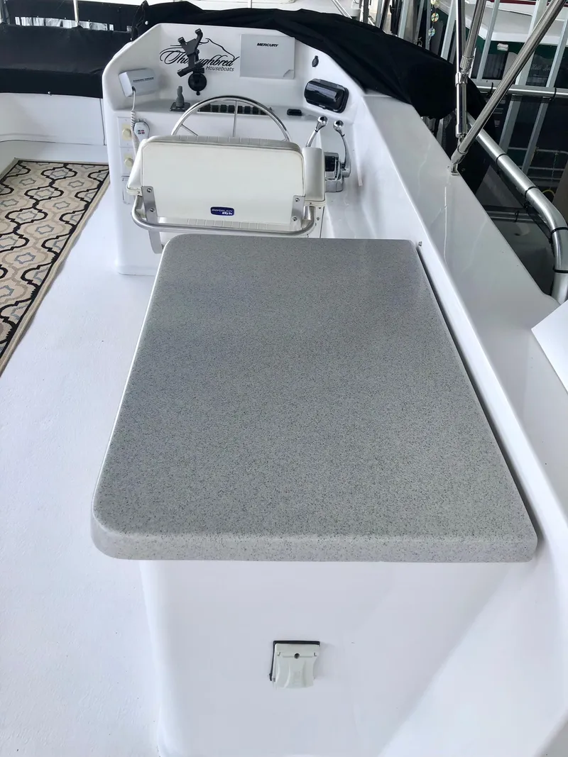 Slide: The Image of Helm station of a 2016 Thoroughbred 67x17 yacht with steering wheel and controls. - 28