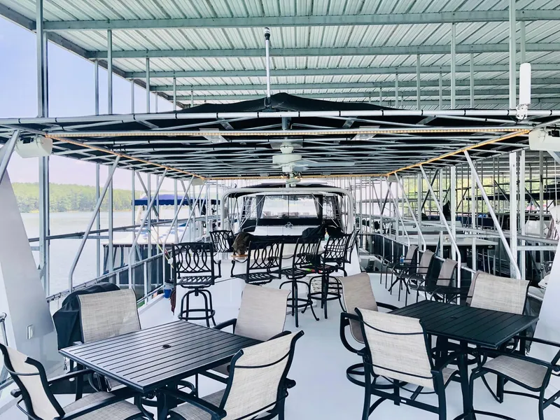 Slide: The Image of Upper deck of a 2016 Thoroughbred 67x17 houseboat with outdoor seating and covered roof. - 29