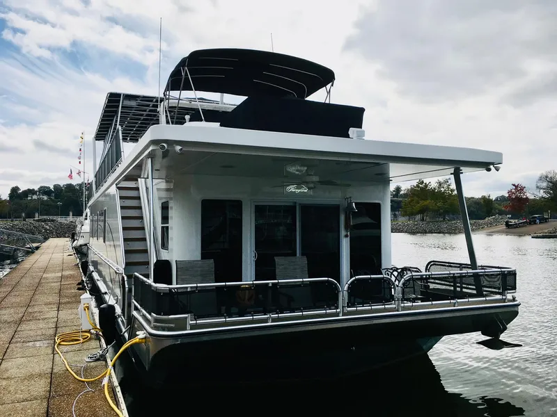 Slide: The Image of 2016 Thoroughbred 67x17 houseboat docked at a marina. - 3
